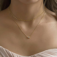 Bridesmaid wearing Gold Layered Necklace featuring Gold Choker and Baguette Pendant Necklace.